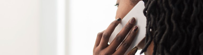 A woman holding a smartphone to her ear