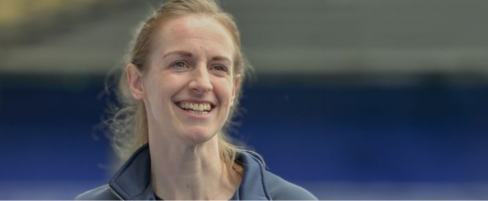 A photo of graduate Kerys Harrop smiling at camera in sport uniform