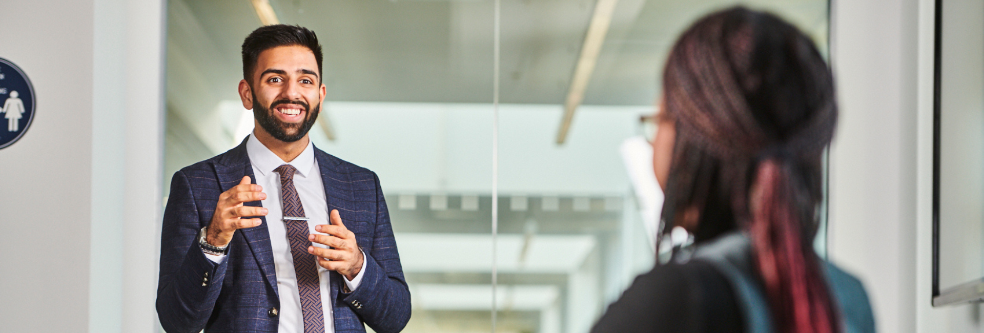 a student in a suit presenting