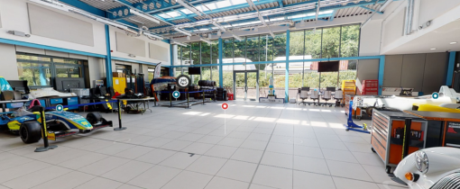 Two students sitting and looking at a laptop screen