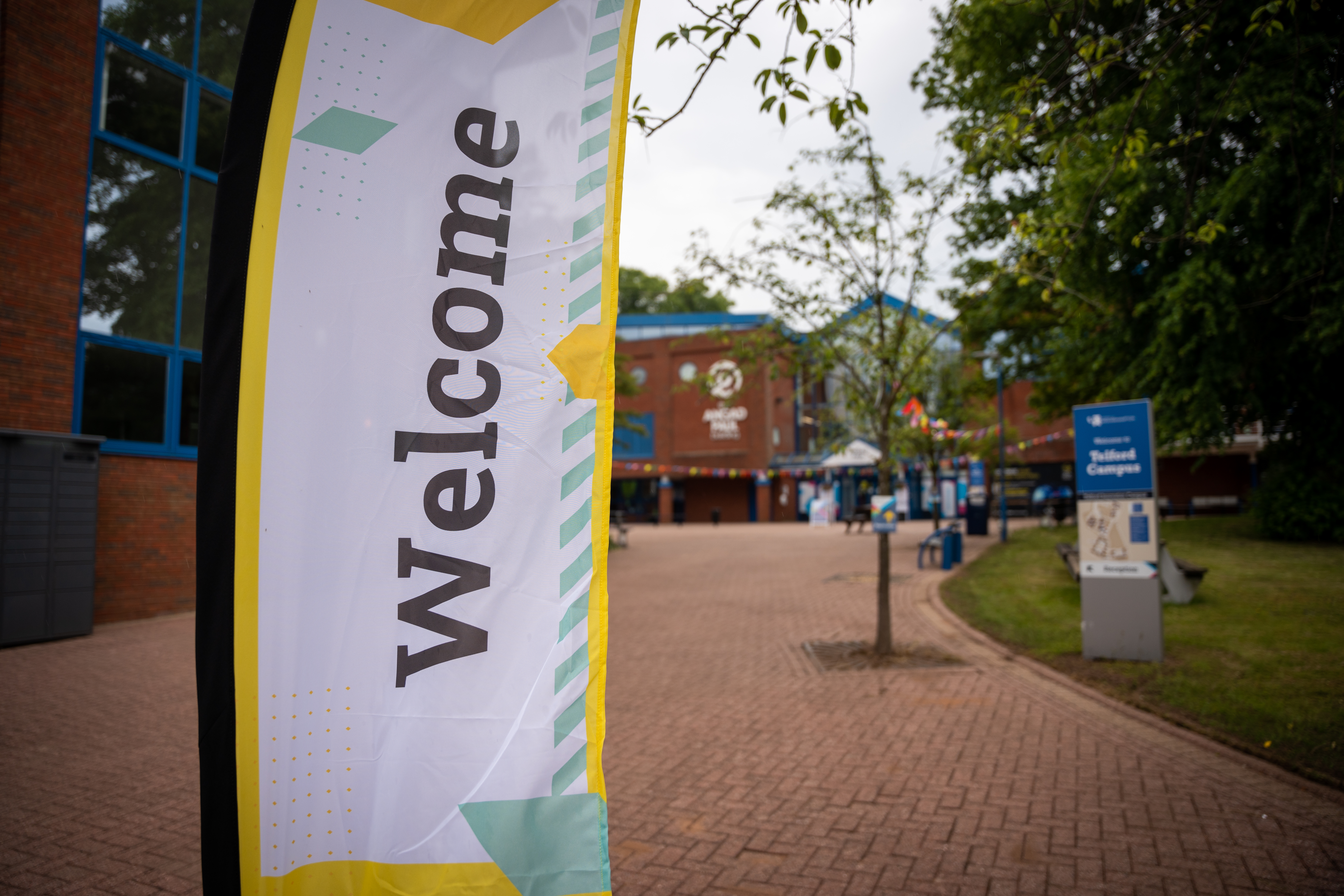 A welcome flag outside the Angad Paul building at Telford Campus