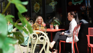 Two people sitting at a table outside the Lupo Lounge restaurant