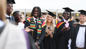 Group of students smiling after graduation ceremony