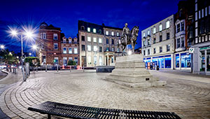 The statue of Prince Albert in Wolverhampton City Centre at night, illuminated by streetlamps
