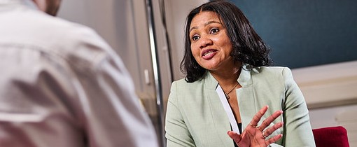 A female speaking with a peer
