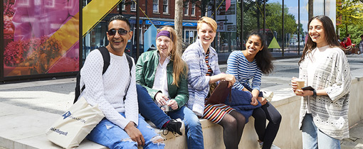 Photo of students sat outside MC Building