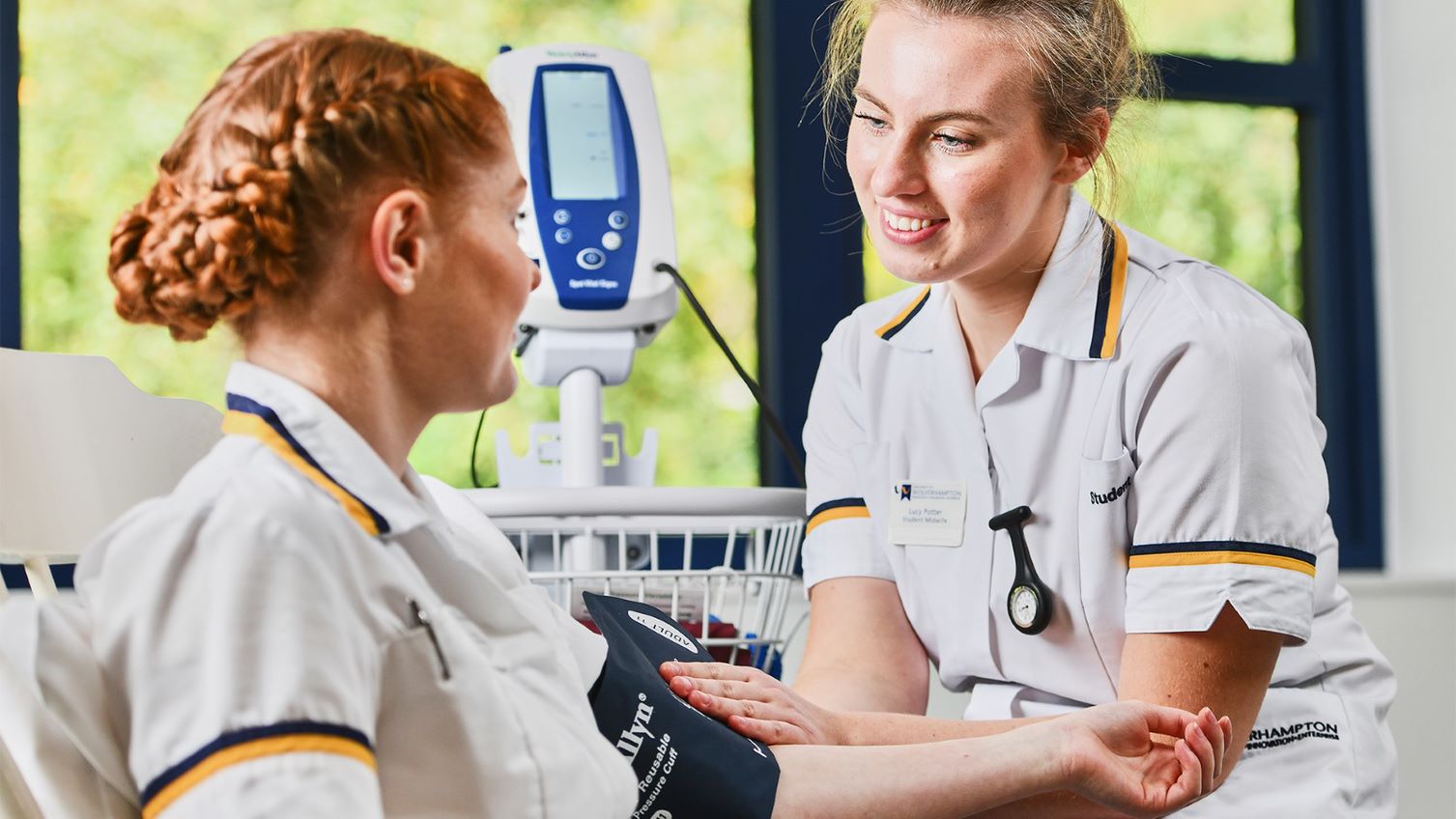 Image of two nurses practicing Adult Nursing using the School of Nursing's mock ward facilities