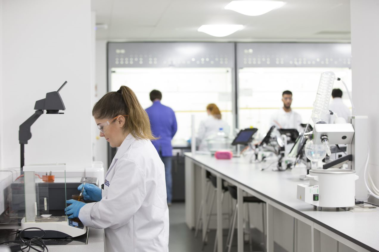 School of Life Sciences laboratory with students in lab coats and safety goggles working with specialist equipment